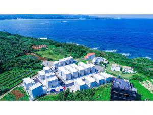 an aerial view of a building near the ocean at Kourijima L'hotels in Nakijin