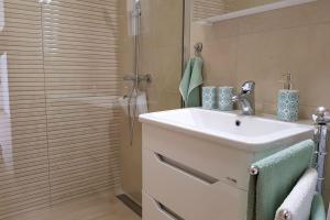 een badkamer met wastafel en douche bij Apartments Mobine in Metković +40 foto's