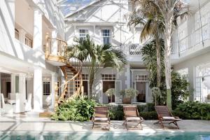 a building with two chairs and a swimming pool at Banksia Boutique Hotel & Spa in Cape Town