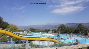a large water park with a yellow slide at Nature Appartements Font Romeu in Font-Romeu