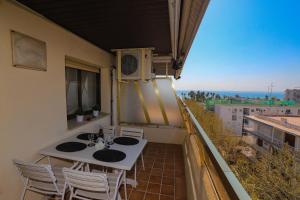 a balcony with a table and chairs on a balcony at COSTA DAURADA APARTAMENTS - Zurbaran in Salou