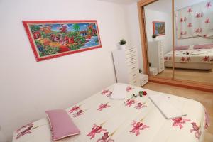 a bedroom with a bed with pink flowers on it at COSTA DAURADA APARTAMENTS - Zurbaran in Salou +18 photos