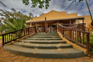 a set of stairs leading to a house at Hluhluwe Country cottages in Hluhluwe