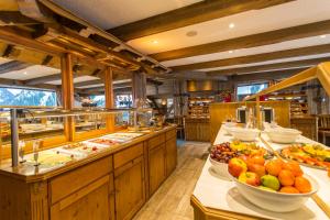 a buffet line with plates of food in a restaurant at Hotel Alte Krone in Mittelberg