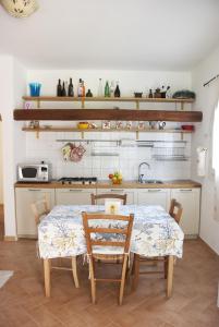 a kitchen with a table and chairs in a room at Case La Filetta in Santa Teresa Gallura