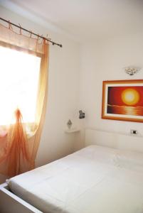 a bedroom with a bed and a window at Case La Filetta in Santa Teresa Gallura