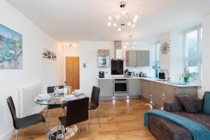 a kitchen and living room with a table and a couch at 10 At The Beach, Torcross in Beesands