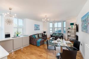 a living room with a table and a couch at 10 At The Beach, Torcross in Beesands