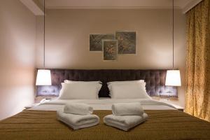 Postel nebo postele na pokoji v ubytování Kentrikon Hotel