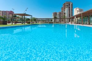 a large swimming pool with blue water at Ag Bermudas Deluxe in Gandía