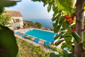 a swimming pool with a view of the ocean at Holiday House Brela in Brela