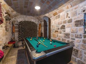 a room with a pool table in a cave at Holiday House Brela in Brela