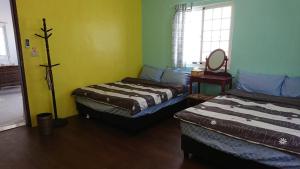 Un pat sau paturi într-o cameră la Haven Seaview Homestay