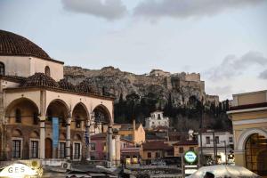 a view of a city with a mountain in the background at Ulysses Apartments Monastiraki in Athens