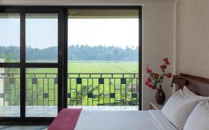 a bed room with a window overlooking a lake at Beleza By The Beach in Colva