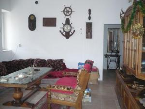 a living room with a couch and a table at LEŚNA OSADA in Tuchlin