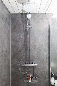 a shower with a shower head in a bathroom at Super Prime Duloch - Dunfermline - 2 Bed Executive Apartment in Dunfermline