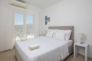 Posteľ alebo postele v izbe v ubytovaní Villa Rozana - Beachfront Wellness Retreat
