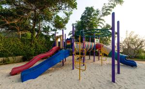 a playground in the sand with colorful slides at Beleza By The Beach in Colva