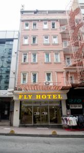 a pink building with a try hotel sign in front of it at Fly Hotel in Istanbul