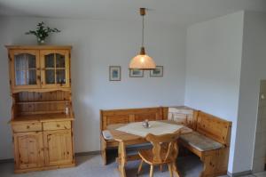 a dining room with a table and a cabinet at Appartements Waldrose in Titisee-Neustadt +6 photos