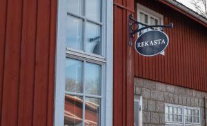 a sign on the side of a red building at Rekasta Bed & Breakfast in Enköping