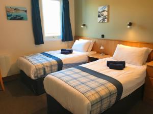 A bed or beds in a room at St Columba Hotel