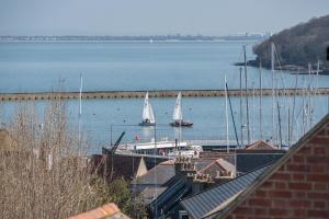 two boats are docked at a marina on the water at Blue Winds and Waves in Cowes