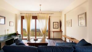 a living room with a couch and a pool table at Fοivos and Athina Villas in Archanes