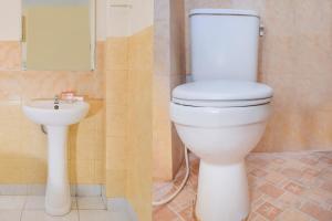 a bathroom with a toilet and a sink at Sabana Homestay in Yogyakarta