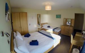 A bed or beds in a room at St Columba Hotel
