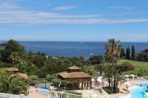 a view of a resort with a pool and a gazebo at Cap Esterel vue Mer in Agay - Saint Raphael