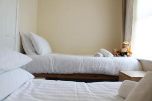 Postel nebo postele na pokoji v ubytování Number 6 Braeside Mews
