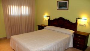 Un pat sau paturi într-o cameră la Alojamientos la Abuela