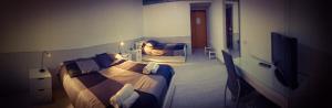 a hotel room with a bed and a television at Affittacamere La Giara in Porto Empedocle
