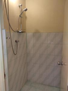 a bathroom with a shower with a shower head at Windsor Forest bungalow in Bandarawela
