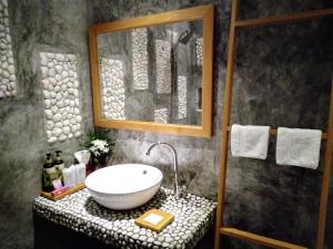 a bathroom with a white sink on a counter at Mingalar Boutique Hotel in Kawthaung