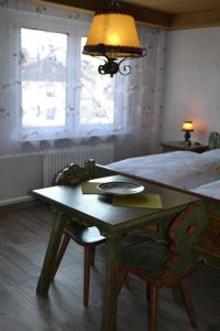 a bedroom with a table and a bed with a lamp at Landgasthaus Krone in St. Johann in Sankt Johann