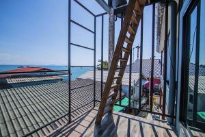 a ladder on the side of a building with a view of the water at Chill Days @ Koh Larn in Ko Larn