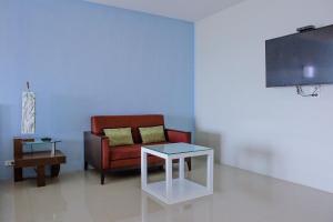 a living room with a red chair and a table at Chill Days @ Koh Larn in Ko Larn