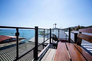 a wooden deck with a bench and the water at Chill Days @ Koh Larn in Ko Larn