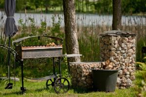 a piano sitting in the grass next to a trash can at Vila Viesai in Trakai