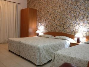 Postel nebo postele na pokoji v ubytování Palates Hotel