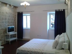 A bed or beds in a room at Apartments Milion