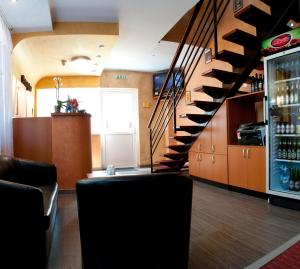 a bar with a spiral staircase in a restaurant at Pensiunea Delia Timișoara in Timişoara