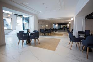 a restaurant with chairs and tables in a building at Hotel Voramar in Benidorm