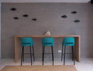 a bar with four black bats on the wall at Hotel Voramar in Benidorm
