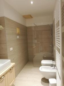 a bathroom with two toilets and a shower at Al Salgiar in Tuenno +27 photos