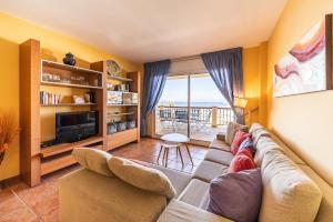 a living room with a couch and a television at Apartment Colette in L'Escala