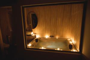 a bathroom with a tub with lights on it at Junior Suites con Jacuzzi in Babilafuente